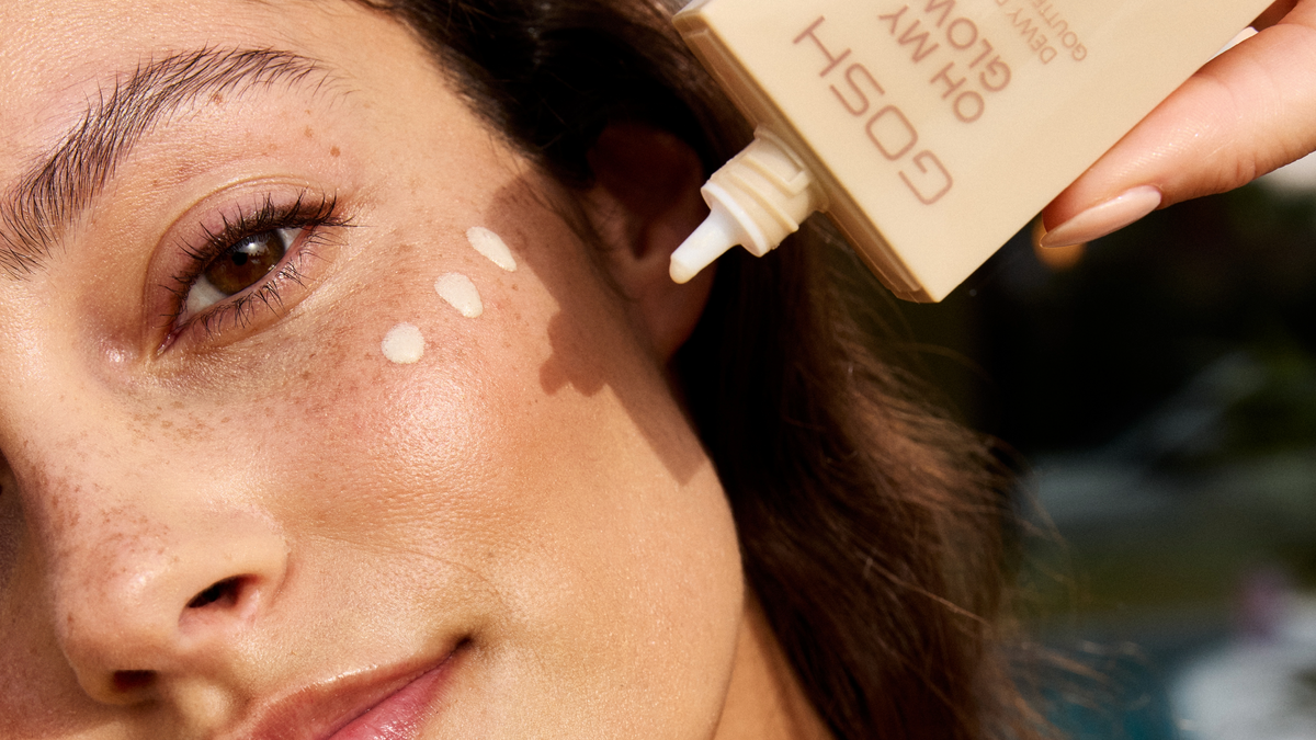 Woman applying foundation to her face