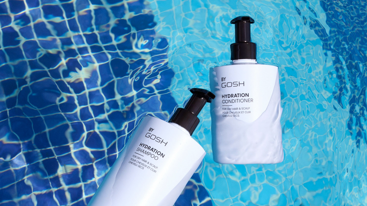 Shampoo and conditioning bottles float in a pool