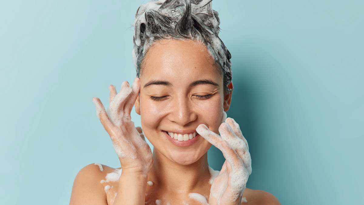 Woman shampooing her head