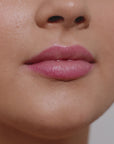 Girl applying  lip gloss