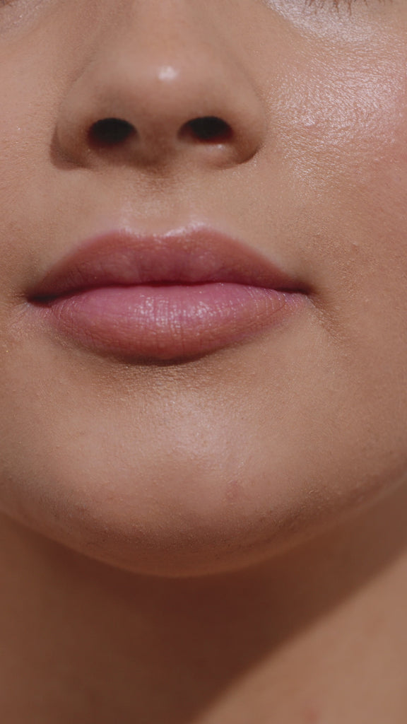 Girl applying lip gloss