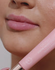Girl applying pink lip gloss